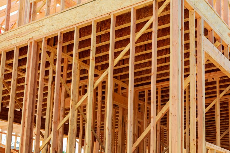 wood framework of new residential home under construction. Home Under Construction